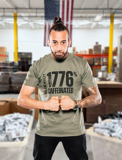 Cutman wearing a green t-shirt with text in a warehouse setting
