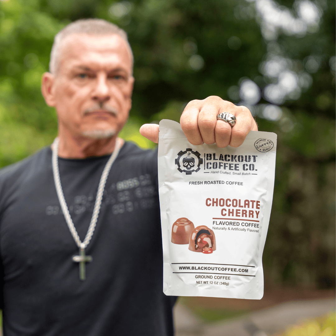 Chocolate cherry man holding the coffee bag
