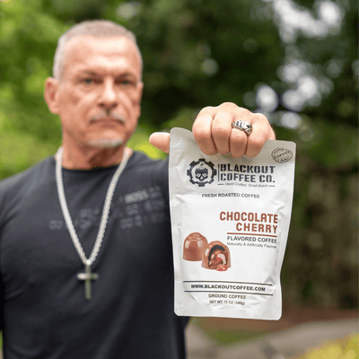 Chocolate cherry man holding the coffee bag