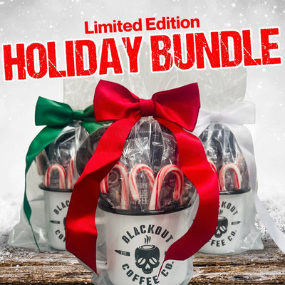 Blackout Coffee Co. holiday bundle with red and green ribbons on a snowy background
