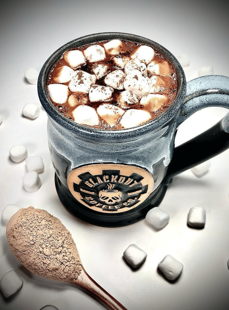 Hot cocoa in a Blackout Coffee mug with marshmallows