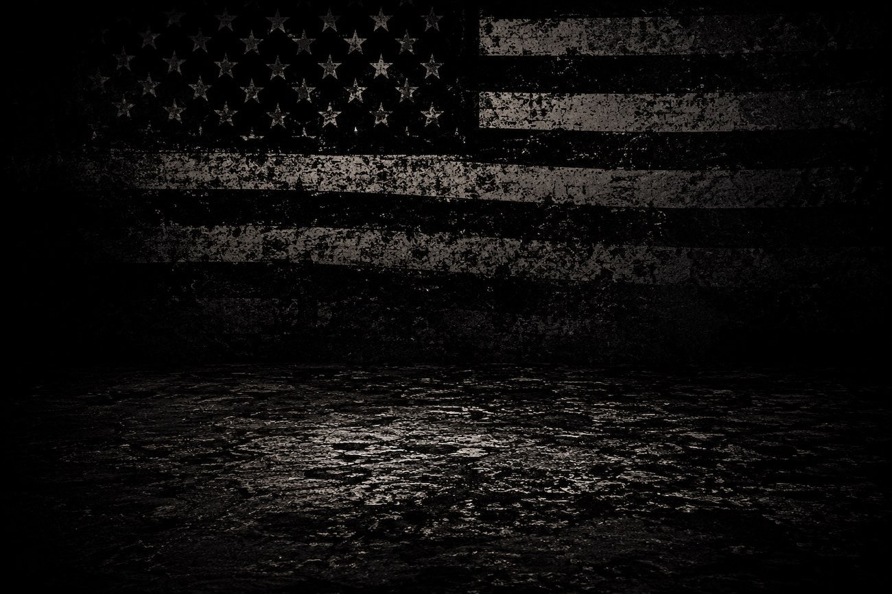 Dark textured background with an American flag design behind Blackout Coffee products