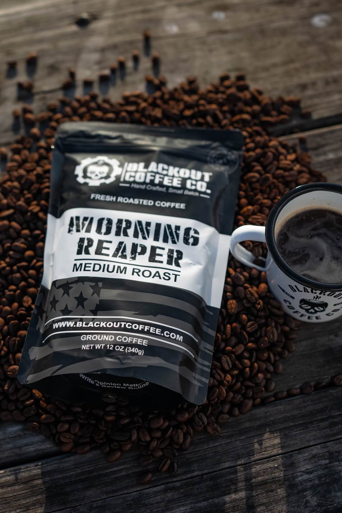 Blackout Coffee Co. Morning Reaper coffee package with a cup of coffee on coffee beans.