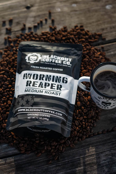 Blackout Coffee Co. Morning Reaper coffee package with a cup of coffee on coffee beans.