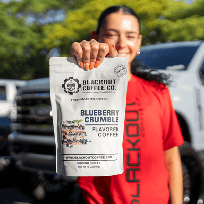 Blackout coffee Blueberry Crumble girl holding the coffee