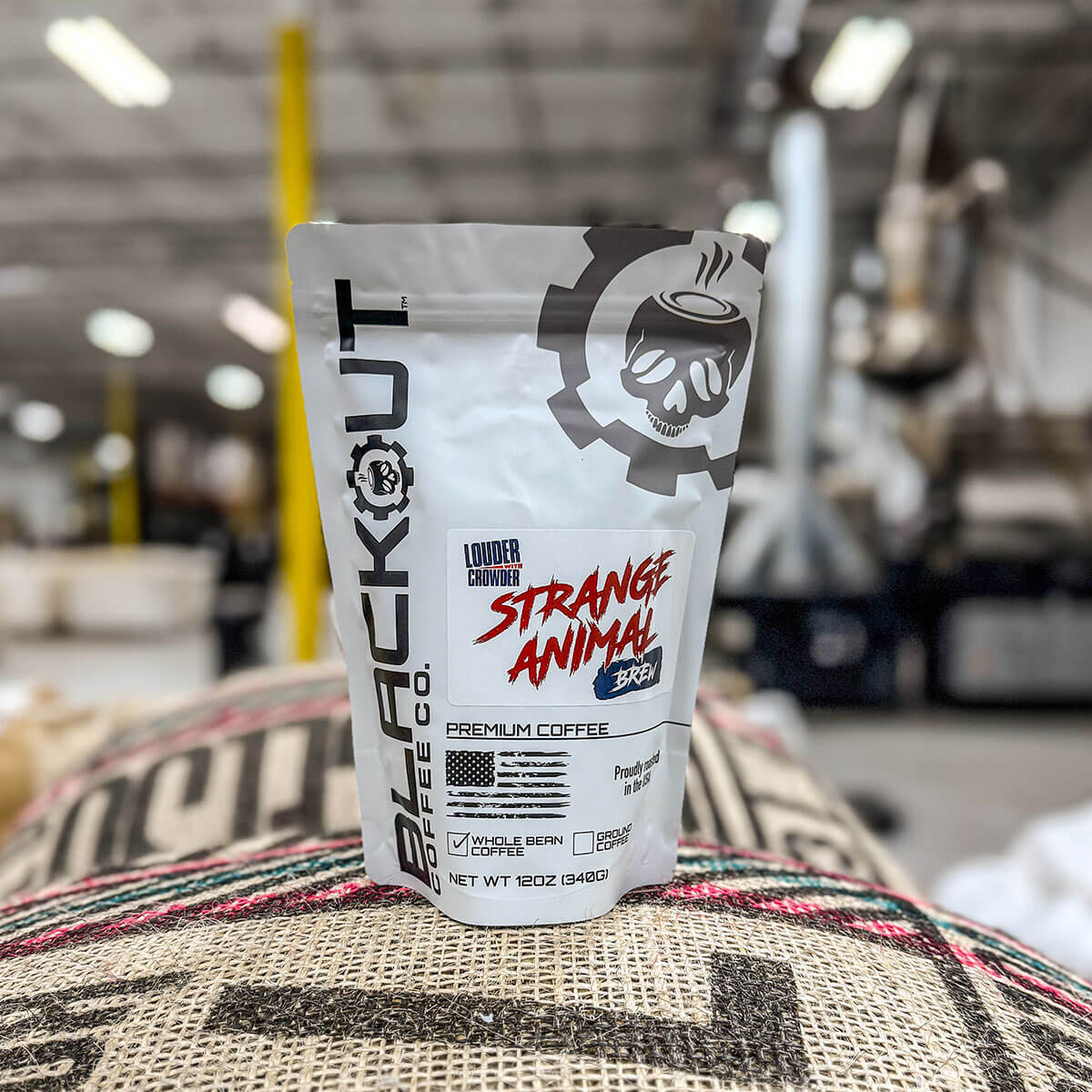 Strange Animal coffee package on a burlap bag with a blurred warehouse background