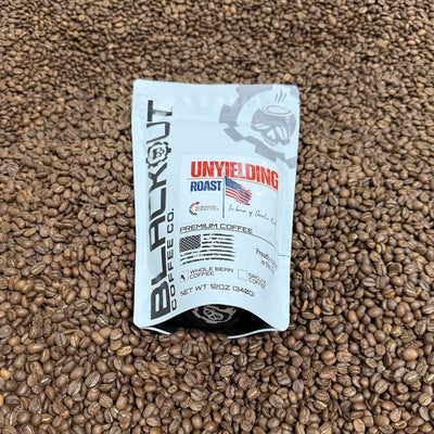 Blackout Coffee Co. Unyielding Roast coffee package on a bed of coffee beans